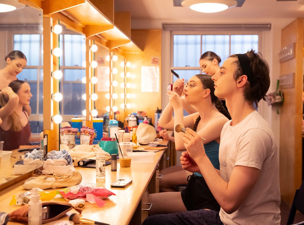 Ballet students at London Studio Centre apply makeup in a theatre dressing room